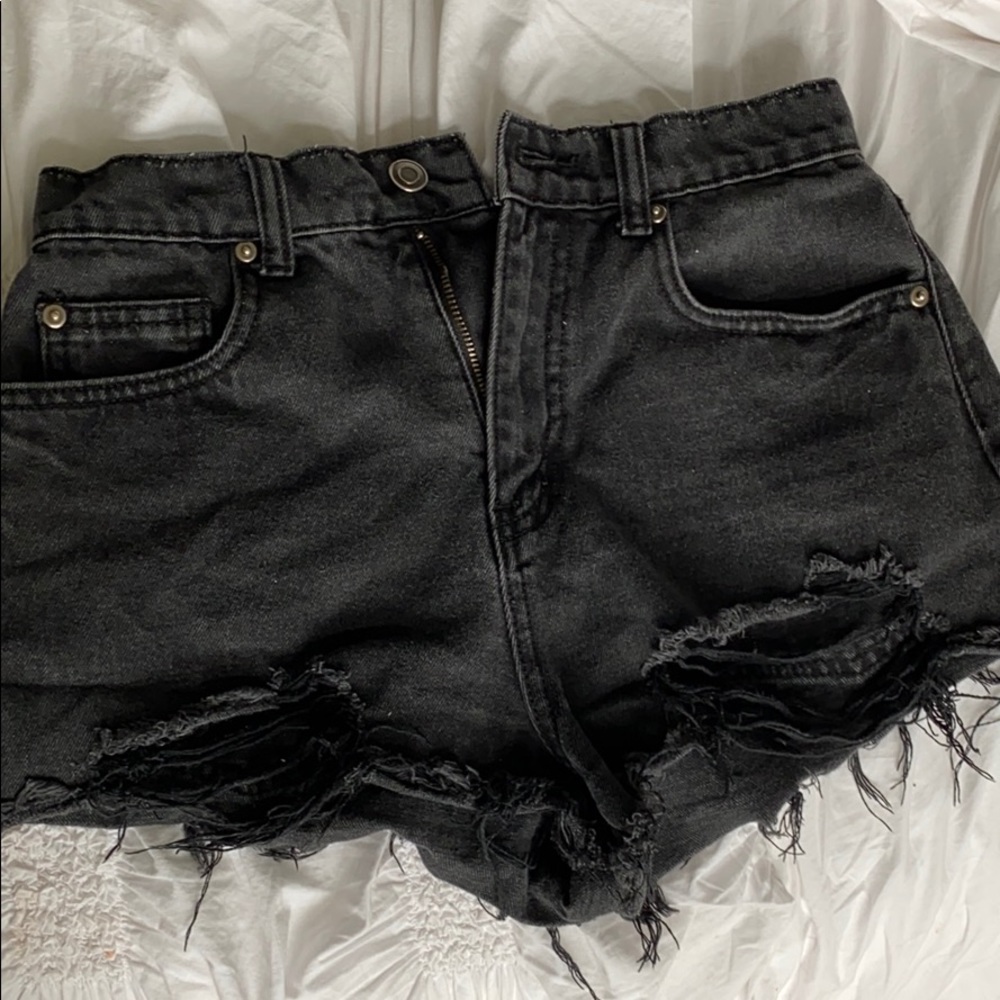 Selling washed black denim shorts